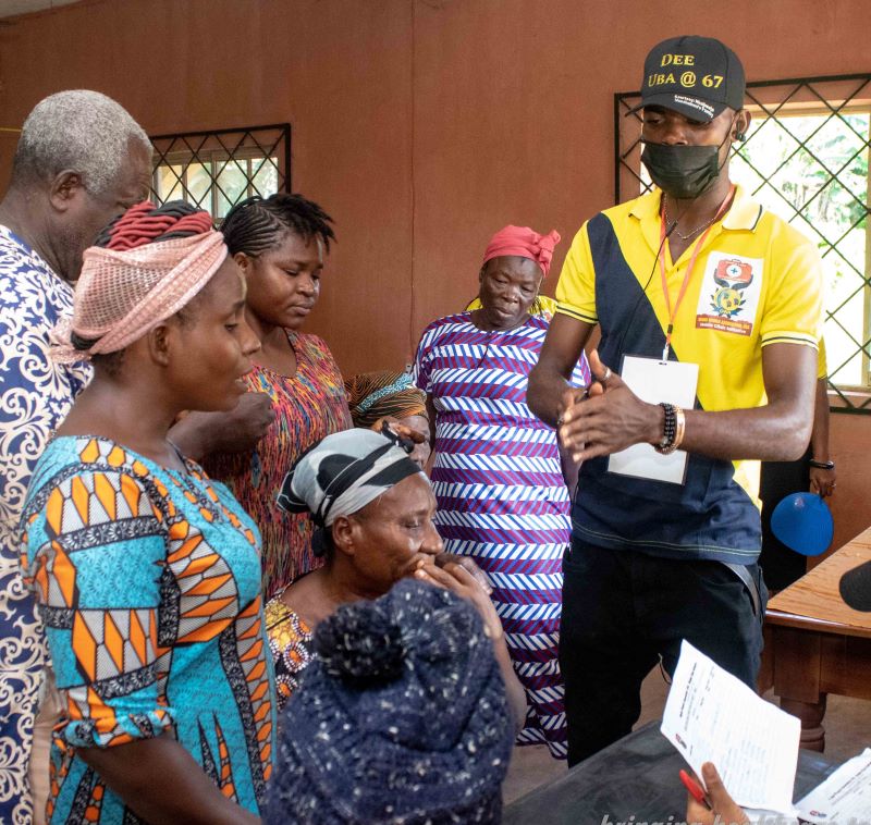 volunteer educating a group community members